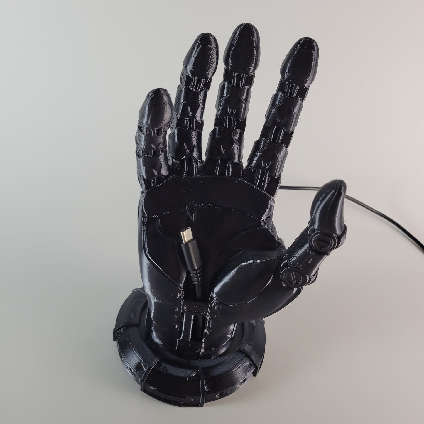 Robot Hand Phone Holder with Hidden Charging port.